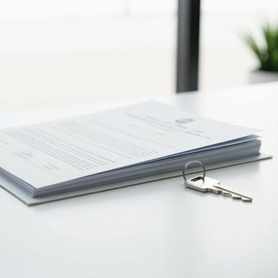 Modern property ownership documents and a house key on a clean desk, symbolizing freehold property investment in the UAE