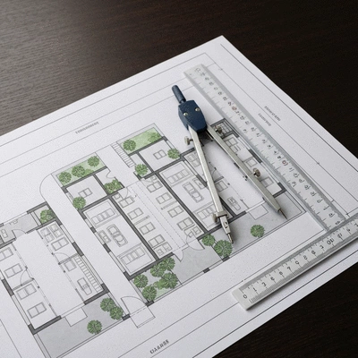 Modern architectural blueprint with a compass and ruler on a desk, representing off-plan property investment planning in the UAE