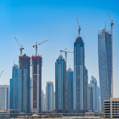Modern Dubai skyline with construction cranes and new buildings, representing off-plan projects